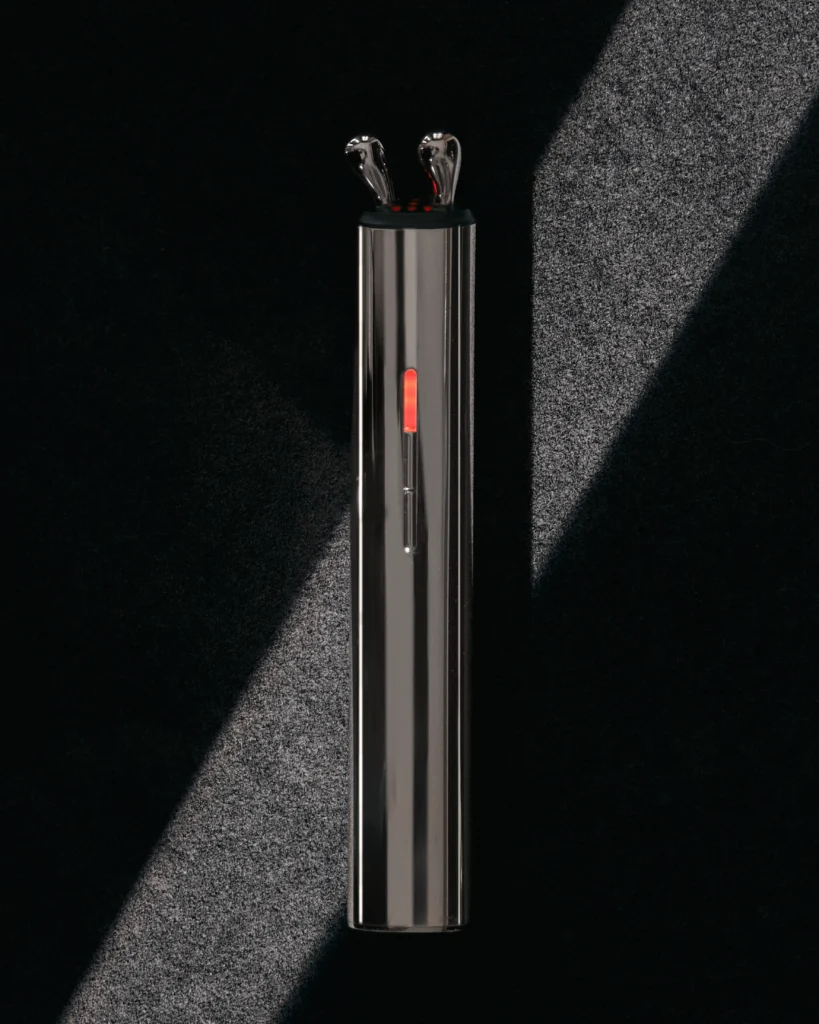 AURA RF masażer liftingujący z podświetleniem LED, leżący pionowo na ciemnym tle.